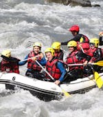 People are paddling within a rapid during the Rafting on the Isère River in Landry - Full Descent with Evolution 2 Peisey Vallandry - H2o Sport.