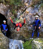 Group picture with a guy hanging upside down during the canyoning trip with OUTdoor Slovenia Bled.