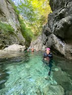 A guy is using the rope to move during the Canyoning in Torrente Palvico in Valle di Ledro with LOLgarda by LiveOutdoorLife.
