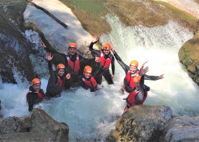 A group of friends is smiling in the canyon during the Canyoning Bachelor Party - Garda by LOLgarda.