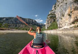 13km Kayak & Canoe Hire in Ardèche - Swim & Sun Having rented a high-quality canoe at Aigue Vive, a woman is enjoying canoeing during the tour "Swim & Sun - 13km" in Ardèche.