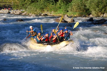 Participants cheering at the camera during the rafting on the Adda River - Adrenaline with Indomita Valtellina River.