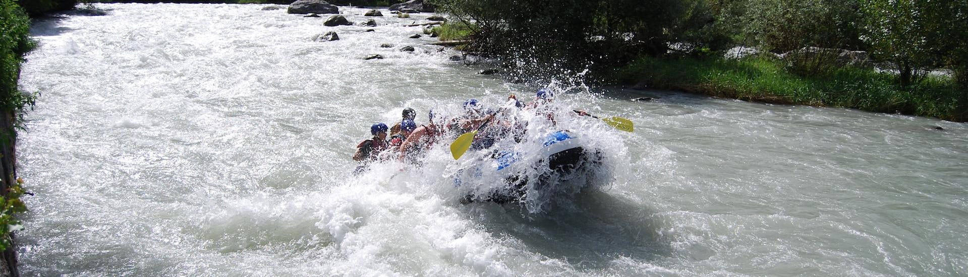 Group of participants having fun during the rafting on the Adda River - Adrenaline with Indomita Valtellina River.