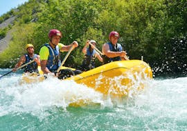 During the Rafting on the Cetina River with City-Transfer from Split, two girls are facing the rapids of the river together with their experienced guide from Adventure Dalmatia.