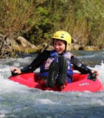 A boy is floating along the river during the Rivertubing on Cetina River organized by Adventure Dalmatia.