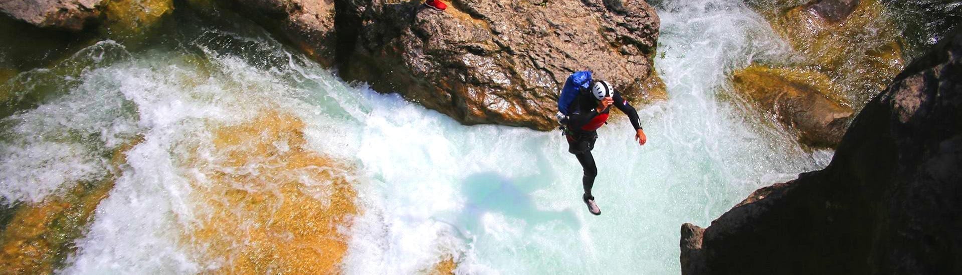 A canyoning guide from Adventure Dalmatia is jumping into the water during the Canyoning for Beginners with City-Transfer from Split at Cetina River.