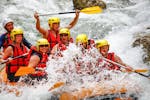 A group of friends is crossing rapids during their Rafting on the Dranse River - Rodeo tour with Evolution 2 Aquarafting Lake Geneva.