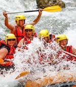 A group of friends is crossing rapids during their Rafting on the Dranse River - Rodeo tour with Evolution 2 Aquarafting Lake Geneva.