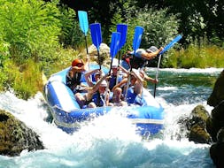 A rafting group mastering the wild rapids of the Cetina River on their Rafting "Classic" Tour with an experienced instructor from Croatia Rafting.