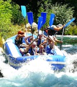 A rafting group mastering the wild rapids of the Cetina River on their Rafting "Classic" Tour with an experienced instructor from Croatia Rafting.
