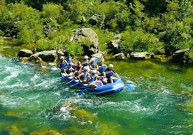 A rafting group paddling down the waters of beautiful Cetina River on their Rafting Tour "Classic" together with a certified guide from Croatia Rafting. 