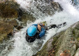 A person is doing canyoning during the Half Day Canyoning near Laruns in Ossau Valley with Expérience Canyon. 