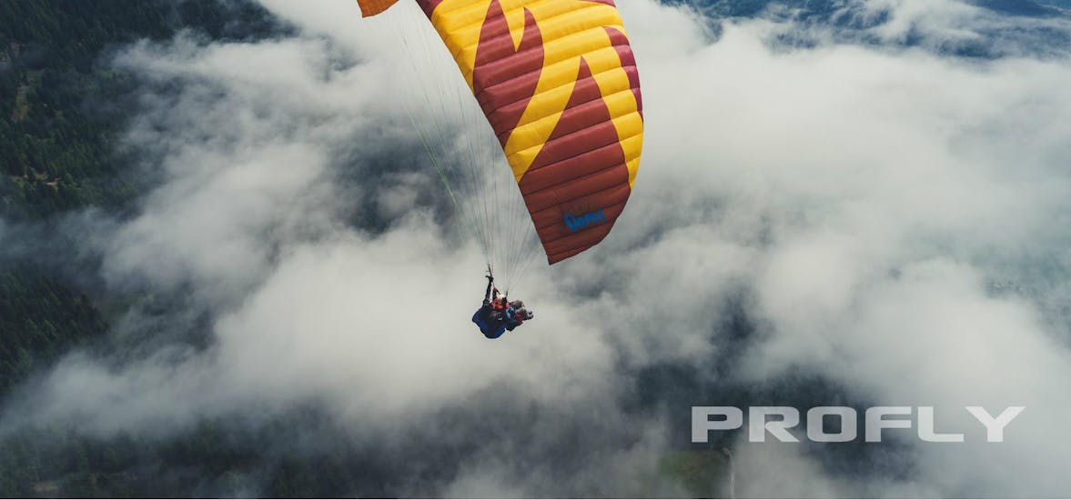 A tandem paragliding flight above the clouds with Best Place - Flieger Base Villach during Tandem Paragliding in Carinthia - Relax Flight.