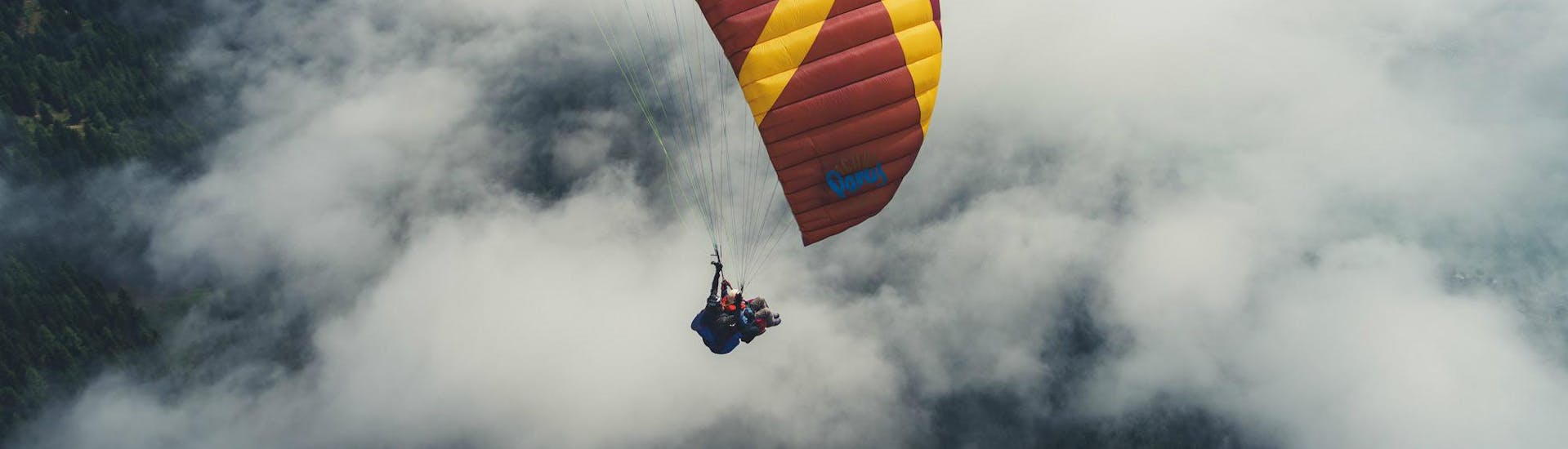 A tandem paragliding flight above the clouds with Best Place - Flieger Base Villach during Tandem Paragliding in Carinthia - Relax Flight.