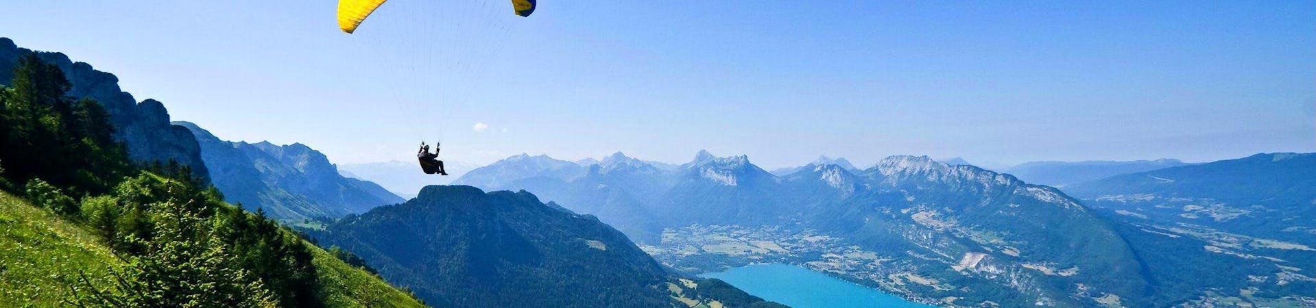 A person is enjoying his Tandem Paragliding in Lake Annecy - Discovery activity with Flyeo.