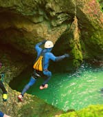 A participant of the Canyoning Adventure in Triglav National Park with 3glav Adventure is jumping into a natural pool.