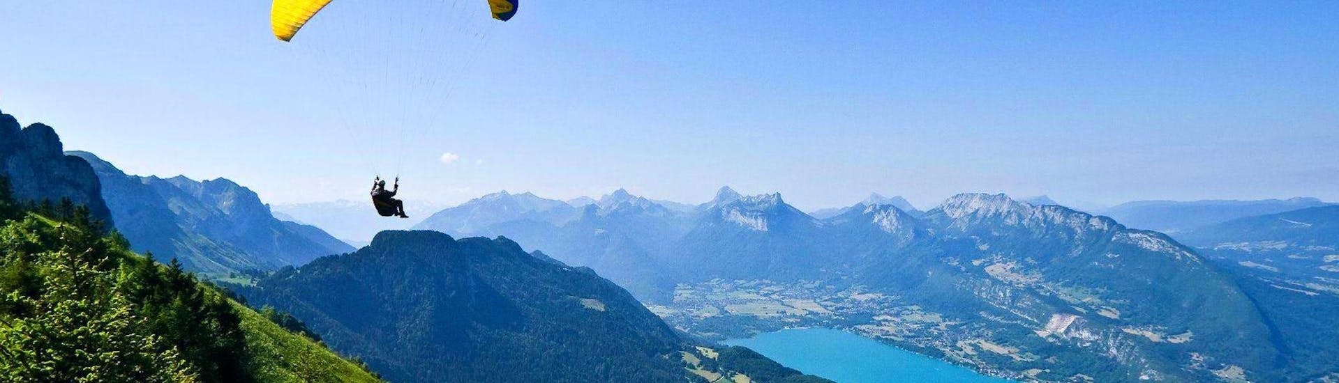 A boy is enjoying his Tandem Paragliding in Lake Annecy for Kids (3-12 years) activity with Flyeo.