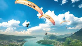 Eine Gruppe von Freunden fliegt beim Tandem Paragliding am Annecy-See, Thermik-Aktivität mit Flyeo.