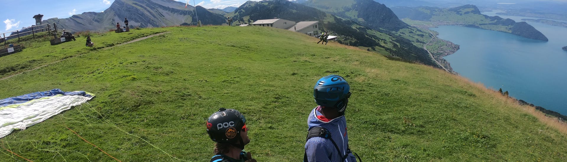 Two persons enjoying the view at Tandem Paragliding from the Niederbauen - Groups with SkyGlide Emmetten-Lucerne.