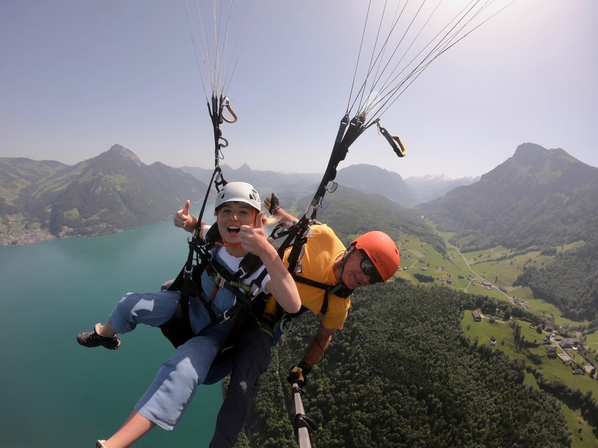 Two persons enjoying Tandem Paragliding from the Niederbauen - Groups with SkyGlide Emmetten-Lucerne.