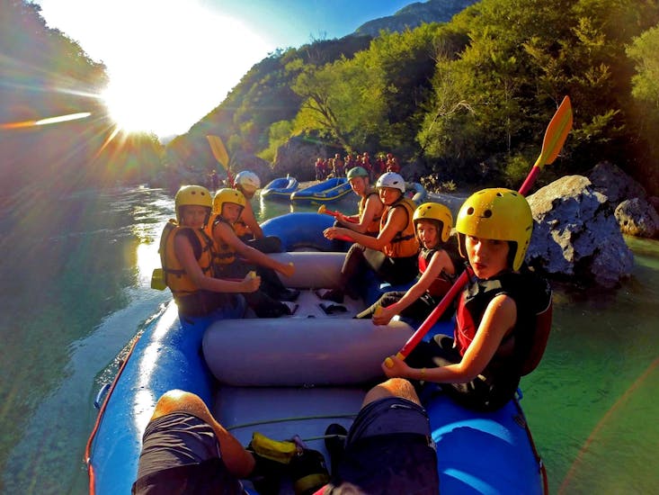 A family with kids sitting in the raft during the Family Rafting Tour on the Soča River in Kobarid with Soča Flow Kobarid.