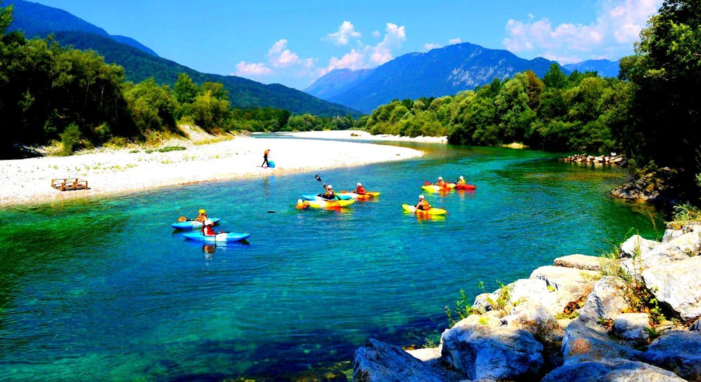 A picture of some participants in kayaks during the Kayaking tour. on the Soča River in Kobarid with Soča Flow Kobarid.