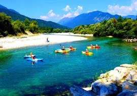 A picture of some participants in kayaks during the Kayaking tour. on the Soča River in Kobarid with Soča Flow Kobarid.
