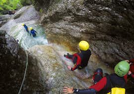 Canyoning in the Sušec Gorge near Kobarid for Beginners with Soča Flow Kobarid. Friends on the natural slide in the gorge while canyoning in the Sušec Gorge near Kobarid for beginners with Soča Flow Kobarid.