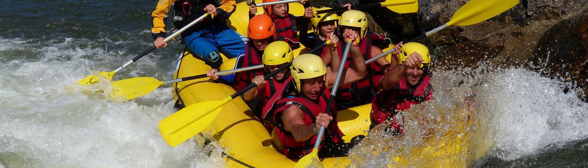 A group of children and adults rafting on the Nive.