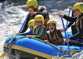 During the Rafting "Family Tour" on Upper Inn, a family is having fun whilst going through some rapids with a certified rafting guide from WhyNot Adventures.