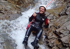 During the Canyoning "First Timer Tour" organised by WhyNot Adventures, a woman is sliding down a natural slide in the canyon Tschingels.