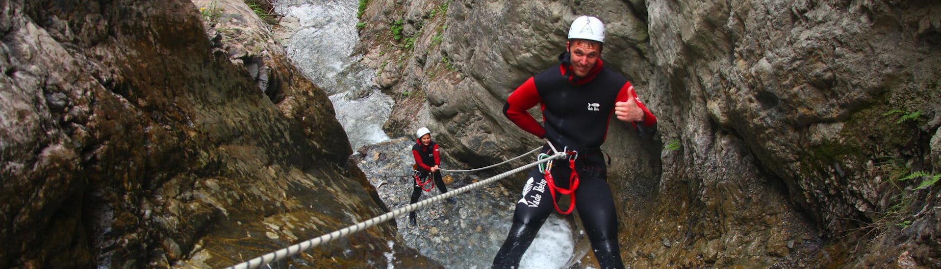 During the Canyoning "First Timer Tour" organised by WhyNot Adventures, a man is enjoying abseiling in the canyon Tschingels.
