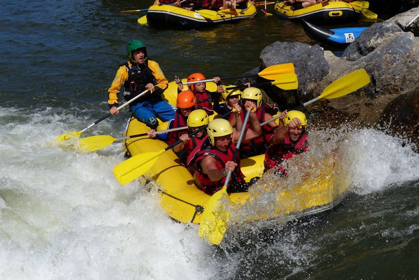 A group of children and adults rafting on the Nive.