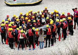 Business Premium Rafting auf der Isar für Firmen (ab 6 Pers) mit Montevia Lenggries Eine Gruppe von Kollegen versammelt sich um ein Schlauchboot und bereitet sich auf das Rafting "Premium Business" für Firmen (ab 8 Personen) auf der Isar mit Montevia vor.
