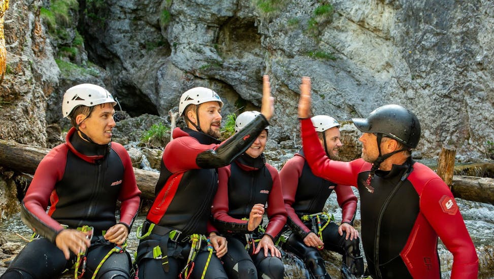 A group of people canyoning in Taxaklamm near St. Johann in Tyrol with The Guide Brixental are having fun.