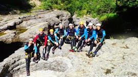 A group of friends resting on a big rock after their adventurous Canyoning Tour in Almbachklamm for Bachelor Parties with Torrent Outdoor Experience.