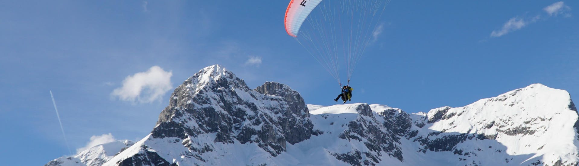 Photo of a guide with a participant in the air during tandem paragliding from the Bischling in Werfenweng - Classic with FlyTandem Salzburg.