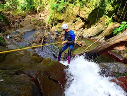 A person is abseiling during a Canyoning in Vauchelet - Tropical Plus activity with Vert Intense.