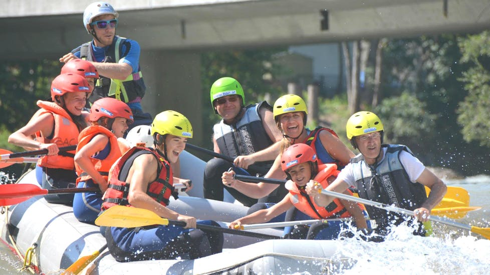 A family is tackling cascades on a raft during the Rafting "Classic" - Enns with the help of an experienced rafting guide from best adventure company.