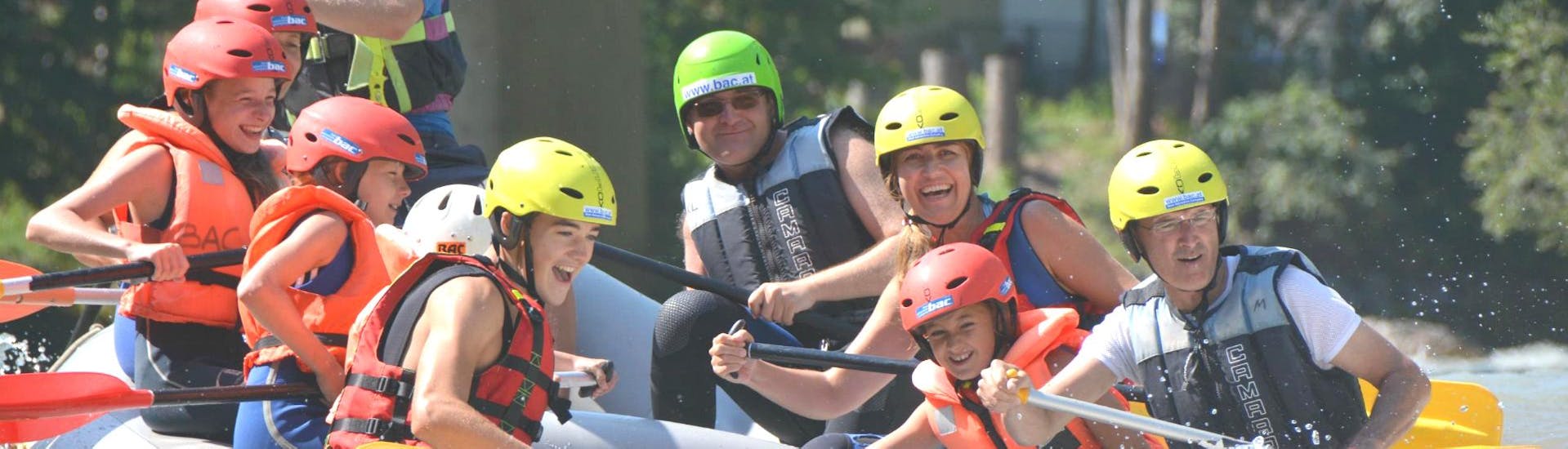 A family is tackling cascades on a raft during the Rafting "Classic" - Enns with the help of an experienced rafting guide from best adventure company.
