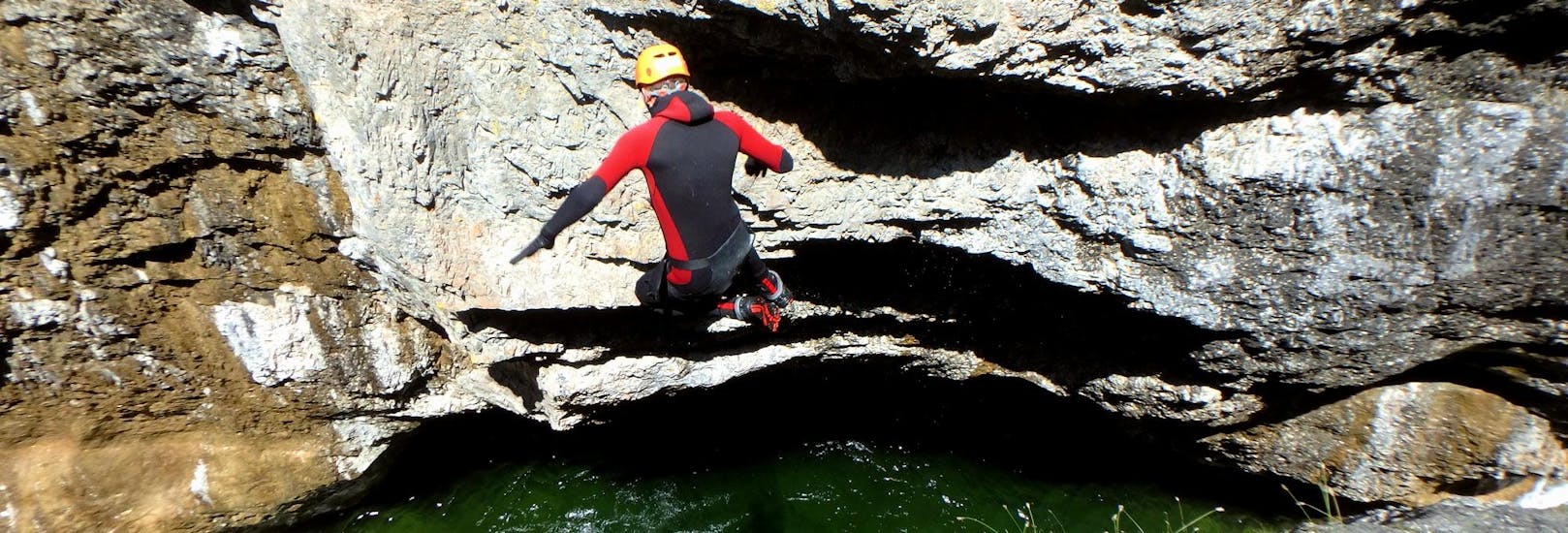 Person on a cliff at Canyoning in Strubklamm - Jumping Jack Flash Tour with Crocodile Sports Salzburg.