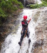 A person enjoying the Canyoning at Erbsattel - Funtastic Tour with Adventure Outdoor Strobl (AOS) Gesäuse.