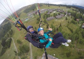 The pilot and a costumer while Tandem Paragliding over Lake Ossiach - Panorama Flight with Flycenter Ossiachersee