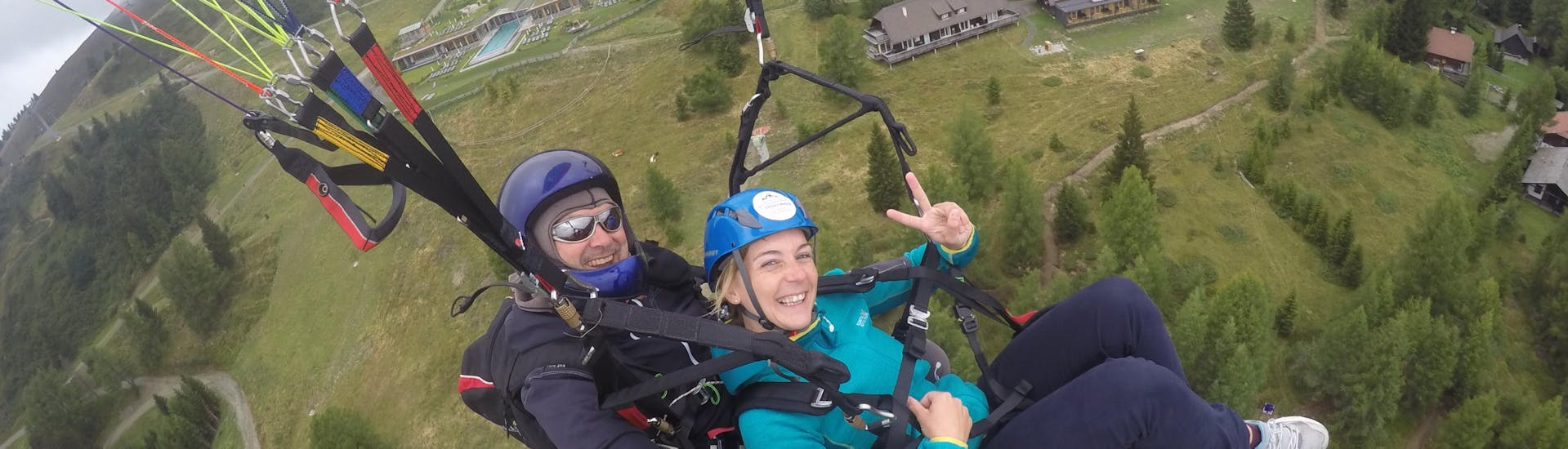 The pilot and a costumer while Tandem Paragliding over Lake Ossiach - Panorama Flight with Flycenter Ossiachersee