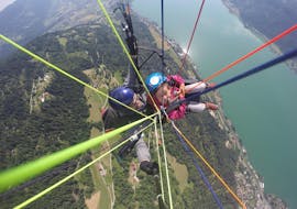 Pilot an costumer above the lake while Tandem Paragliding over Lake Ossiach - Action Flight with Flycenter Ossiachersee
