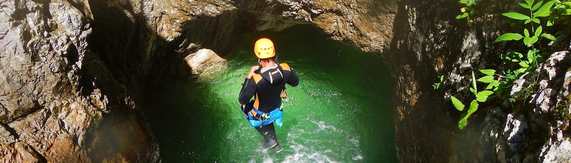 A person jumping into the water at Adventurous Canyoning near Lake Weissensee in Carinthia with ARES Drautal Canyoning.