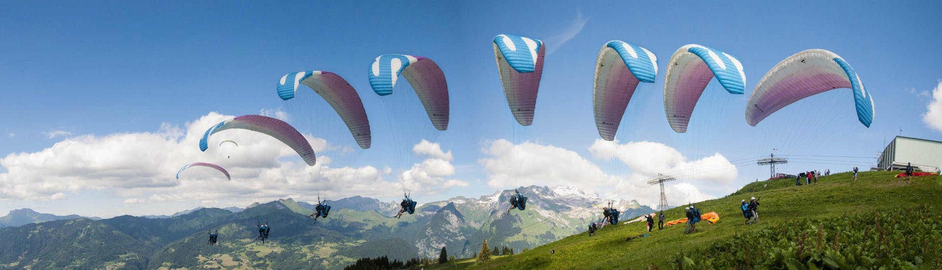 A paragliding pilot from Pegase Air is taking off from one of the moutains surrounding Samoens for a Tandem Paragliding Flight "Discovery".
