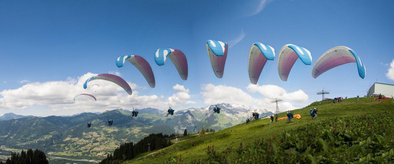 A paragliding pilot from Pegase Air is taking off from one of the moutains surrounding Samoens for a Tandem Paragliding Flight "Take Control".
