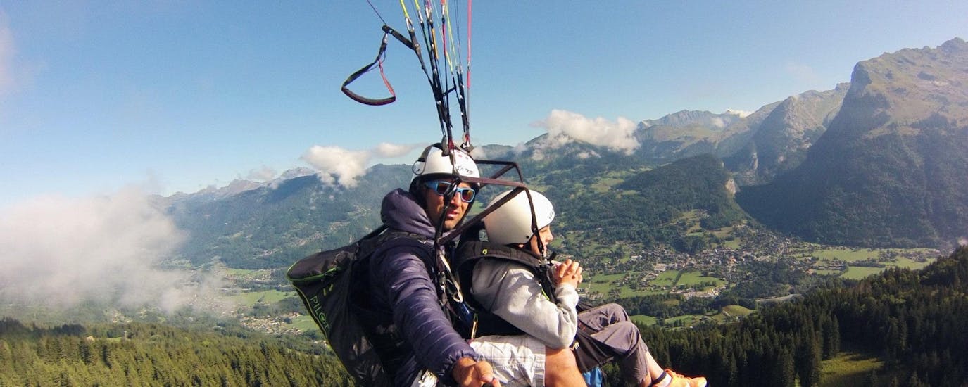 A child makes a Tandem Paragliding flight "Young Highlander" with Pegase Air over the Samoens valley.