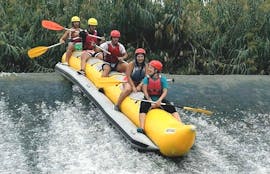 People are having fun whilst riding down a river during the Rafting "Banana Boat" - Rio Segura organised by Rafting Murcia.